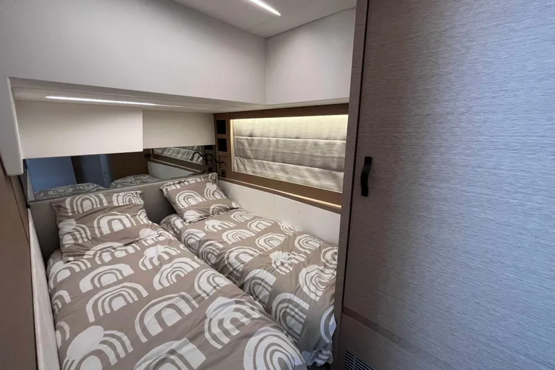  Yacht Photos Pics Modern twin bedroom in 2023 Prestige 520 yacht, featuring stylish bedding and ambient lighting.