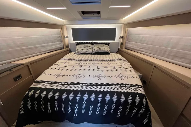  Yacht Photos Pics Luxurious bedroom interior of 2023 Prestige 520 yacht with elegant bedding and ambient lighting.