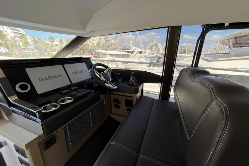  Yacht Photos Pics Interior of 2023 Prestige 520 yacht with Garmin navigation system and leather seating.
