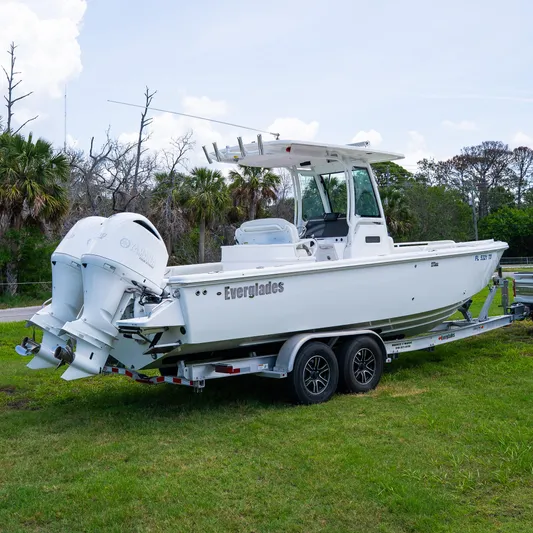  Yacht Photos Pics 2021 Everglades 273 Center Console boat on trailer, parked on grass.