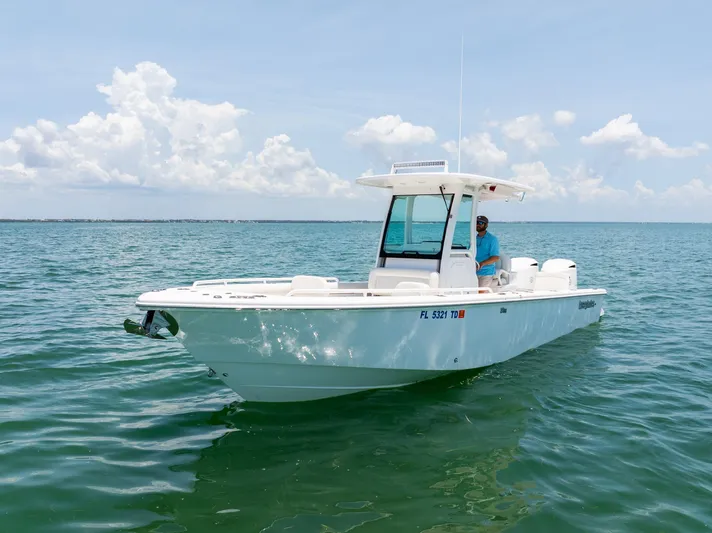  Yacht Photos Pics 2021 Everglades 273 Center Console boat on calm ocean waters under a clear sky.
