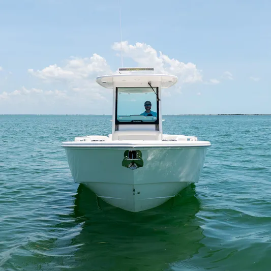  Yacht Photos Pics 2021 Everglades 273 Center Console boat on calm ocean waters under a clear sky.