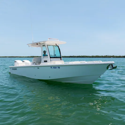  Yacht Photos Pics 2021 Everglades 273 Center Console boat on clear water, side view.