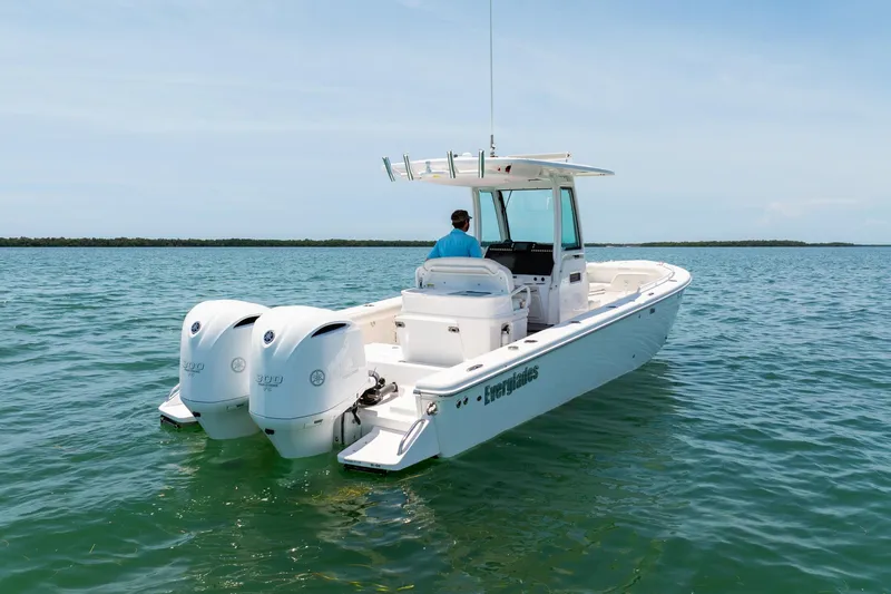  Yacht Photos Pics 2021 Everglades 273 Center Console boat on calm water, featuring dual engines.