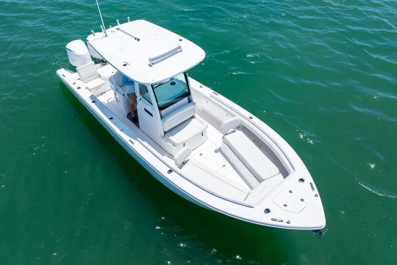  Yacht Photos Pics 2021 Everglades 273 Center Console boat on clear green water.