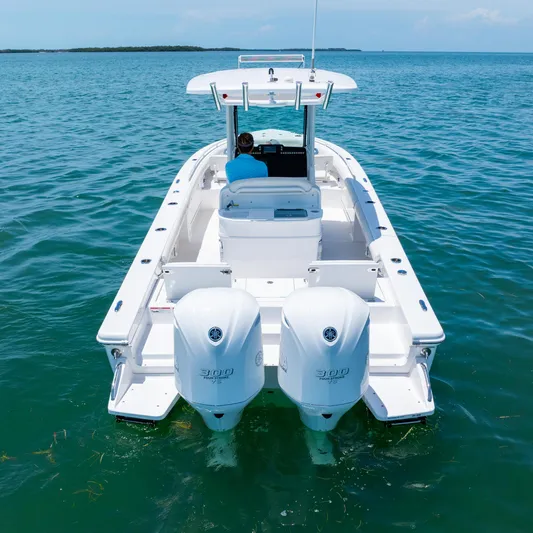  Yacht Photos Pics 2021 Everglades 273 Center Console boat on open water, rear view.