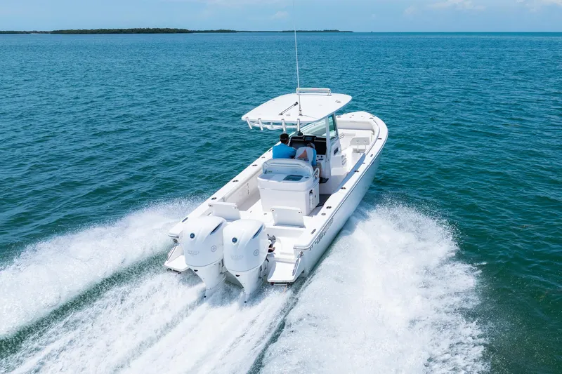  Yacht Photos Pics 2021 Everglades 273 Center Console boat cruising on open water.