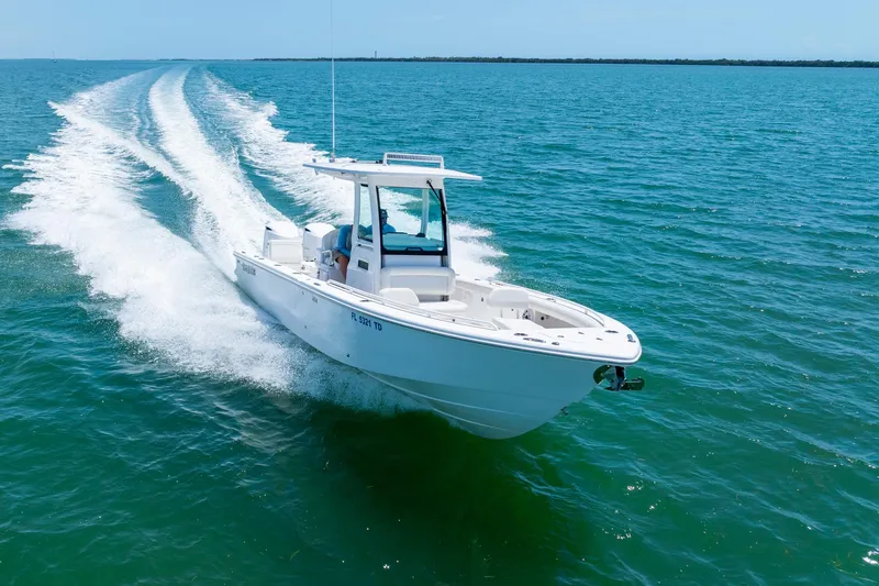  Yacht Photos Pics 2021 Everglades 273 Center Console boat cruising on open water.
