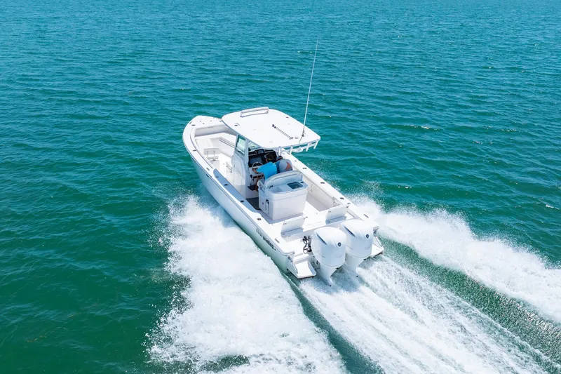  Yacht Photos Pics 2021 Everglades 273 Center Console boat cruising on open water.