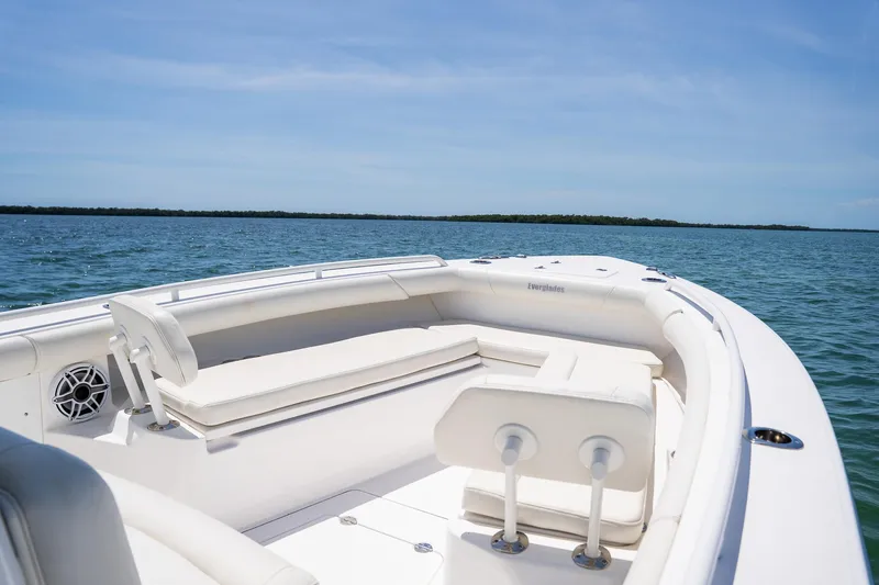  Yacht Photos Pics 2021 Everglades 273 Center Console boat on calm water, featuring spacious seating.