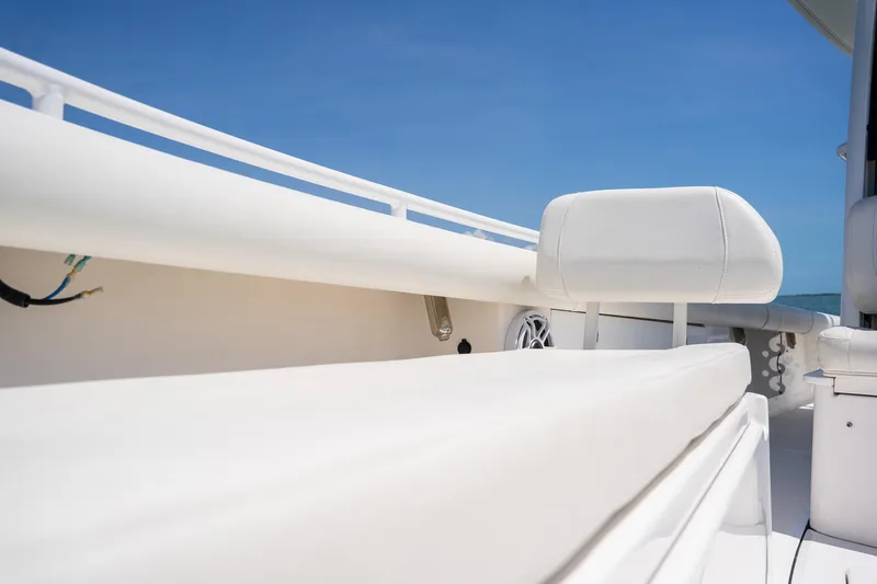 Yacht Photos Pics 2021 Everglades 273 Center Console boat interior with white seating and clear blue sky.