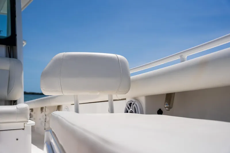  Yacht Photos Pics 2021 Everglades 273 Center Console boat interior with white seating and clear blue sky.