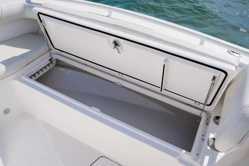  Yacht Photos Pics Open storage compartment on 2021 Everglades 273 Center Console boat, near water.