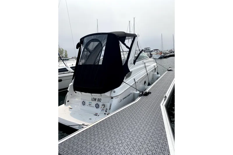  Yacht Photos Pics 2023 Regal 28 Express boat docked at marina, featuring sleek design and black canopy.
