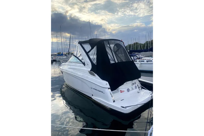  Yacht Photos Pics 2023 Regal 28 Express boat docked at marina under cloudy sky.