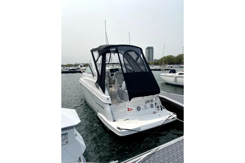  Yacht Photos Pics 2023 Regal 28 Express boat docked in marina, featuring sleek design and black canopy.