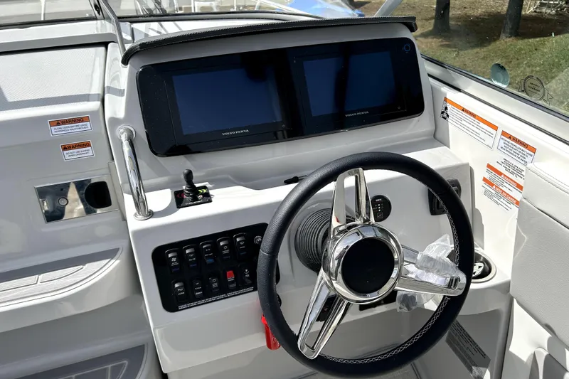  Yacht Photos Pics 2023 Regal 28 Express boat dashboard with steering wheel and digital displays.
