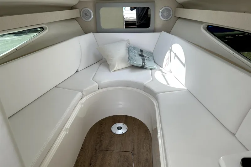  Yacht Photos Pics 2023 Regal 28 Express cabin interior with white seating and wood flooring.