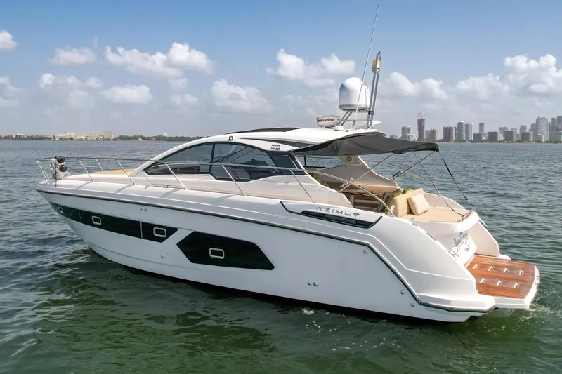 Above & Beyond Yacht Photos Pics Azimut 43 ATLANTIS 2016 yacht cruising on open water with city skyline in background.