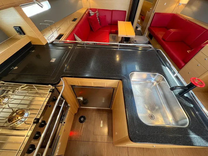 Xaca Yacht Photos Pics Luxurious 2015 X-Yachts Xp 55 yacht interior with modern kitchen and red seating area.