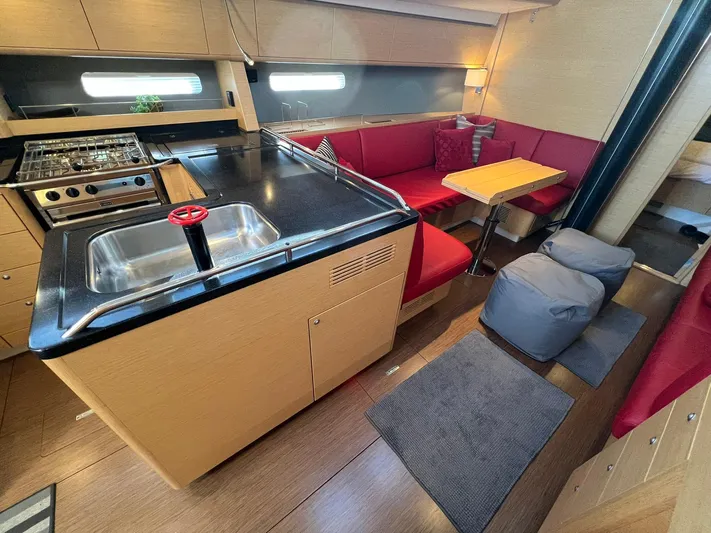 Xaca Yacht Photos Pics Luxurious interior of 2015 X-Yachts Xp 55 with modern kitchen and cozy seating area.