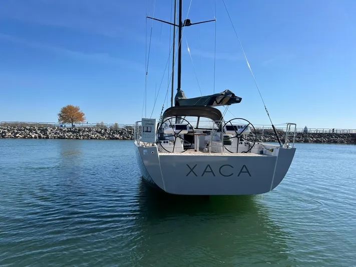 Xaca Yacht Photos Pics 2015 X-Yachts Xp 55 sailboat on calm water, rear view.