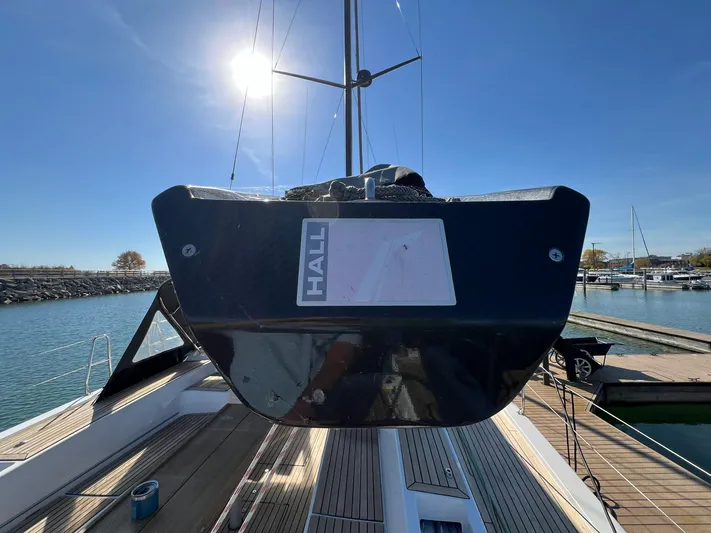 Xaca Yacht Photos Pics 2015 X-Yachts Xp 55 sailboat docked, viewed from the stern under a clear blue sky.