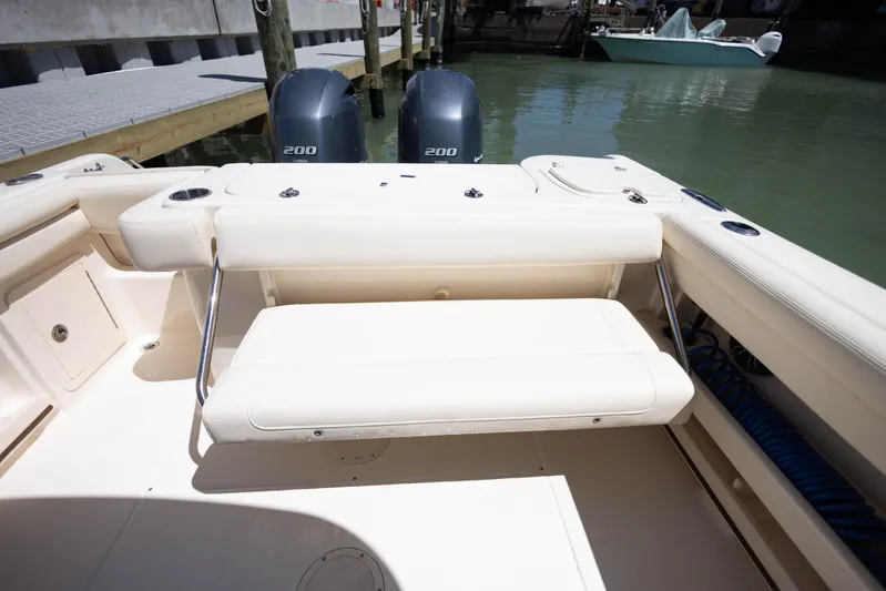  Yacht Photos Pics 2021 Grady-White Freedom 275 boat with dual engines, docked in a marina.