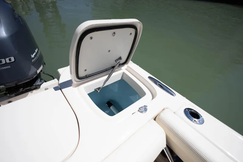  Yacht Photos Pics 2021 Grady-White Freedom 275 boat with open storage compartment near engine.