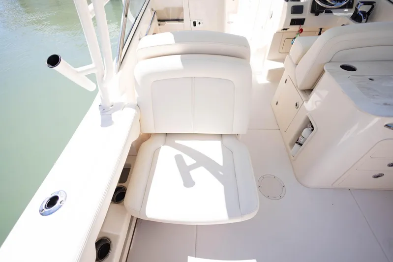  Yacht Photos Pics 2021 Grady-White Freedom 275 boat interior with white seating and fishing rod holders.