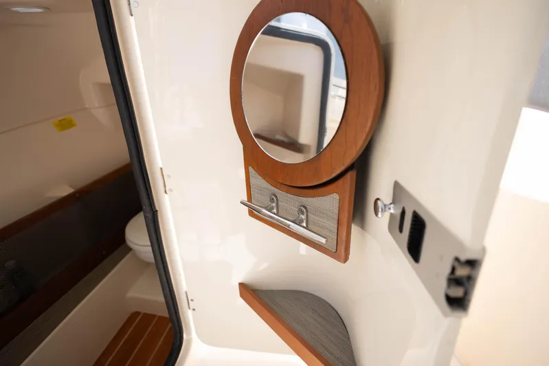  Yacht Photos Pics 2021 Grady-White Freedom 275 interior cabin with mirror and storage.
