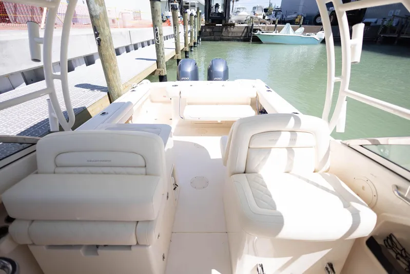  Yacht Photos Pics 2021 Grady-White Freedom 275 boat interior with seating, docked at marina.
