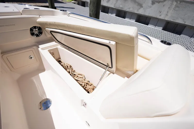  Yacht Photos Pics 2021 Grady-White Freedom 275 boat with open storage compartment and coiled rope.