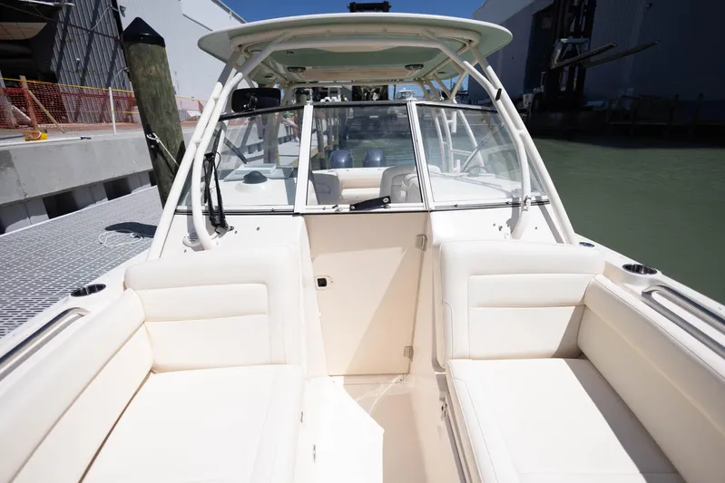  Yacht Photos Pics 2021 Grady-White Freedom 275 boat interior with white seating at dock.