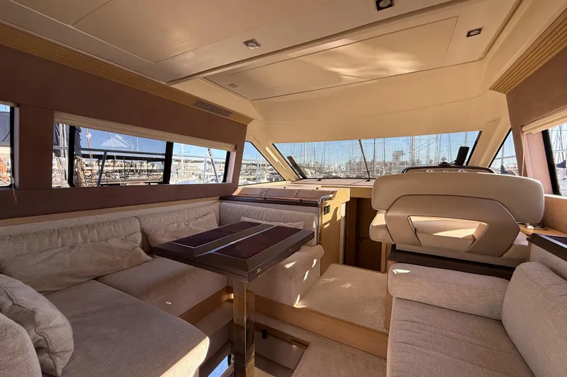  Yacht Photos Pics Luxurious interior of 2018 Beneteau Monte Carlo 5 yacht with plush seating and panoramic windows.