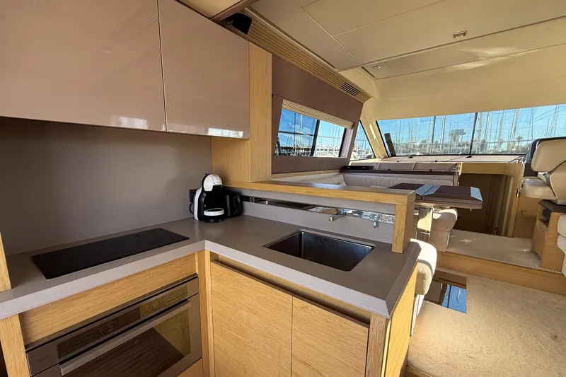  Yacht Photos Pics Luxurious interior of 2018 Beneteau Monte Carlo 5 yacht with modern kitchen amenities.
