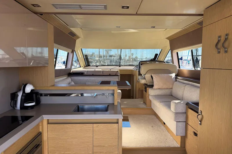  Yacht Photos Pics Luxurious interior of 2018 Beneteau Monte Carlo 5 yacht with modern kitchen and seating area.