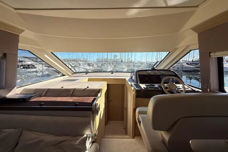  Yacht Photos Pics Interior view of 2018 Beneteau Monte Carlo 5 yacht, featuring helm and luxurious seating.