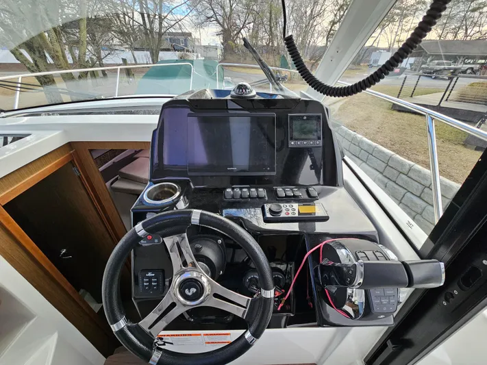  Yacht Photos Pics Cockpit of 2020 Beneteau Antares 9 with steering wheel and navigation controls.