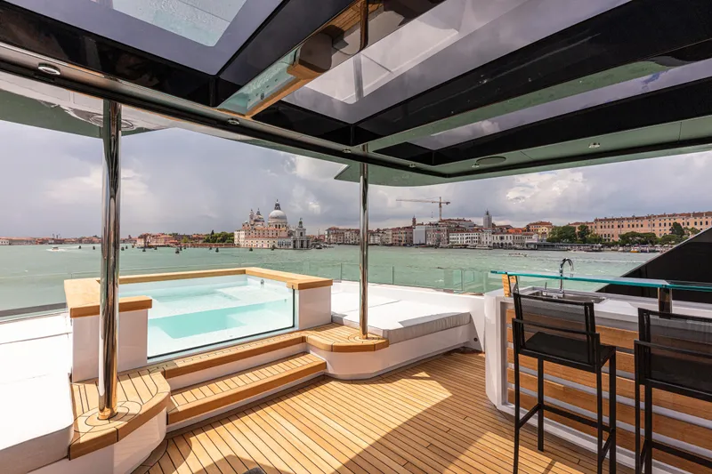 Ducale 120 Yacht Photos Pics Luxurious Ocean King Ducale 120 yacht deck with pool, bar, and scenic waterfront view, 2027 model.