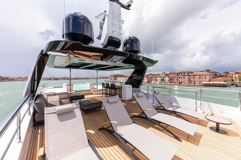Ducale 120 Yacht Photos Pics Luxurious Ocean King Ducale 120 yacht deck with sun loungers, overlooking scenic waterfront, 2027 model.