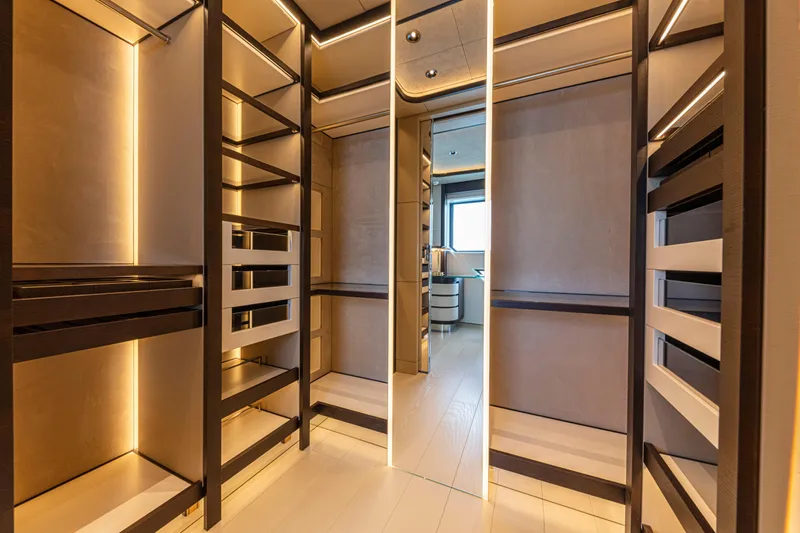 Ducale 120 Yacht Photos Pics Luxurious walk-in closet on Ocean King Ducale 120 yacht, 2027 model, with elegant lighting.
