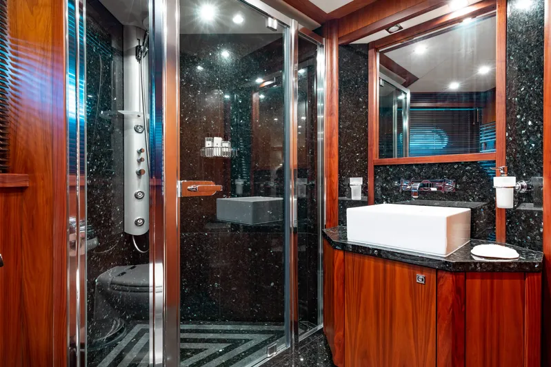 Mercy Yacht Photos Pics Luxurious bathroom in 2009 Sunseeker 121 yacht with wood accents and modern fixtures.