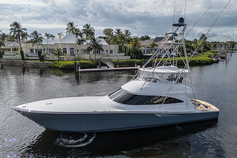 Lady Surfbum Yacht Photos Pics 2024 Viking 72 Convertible yacht cruising near luxury waterfront homes.