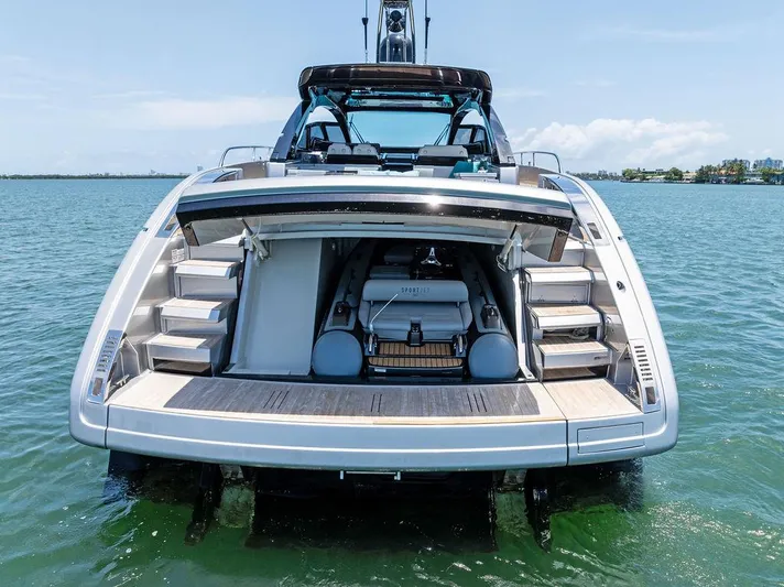 Club T Yacht Photos Pics 2023 Riva 68 Diable yacht with open rear deck, showcasing luxurious design on the water.