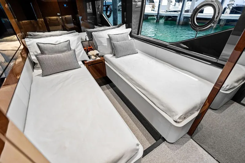 Club T Yacht Photos Pics Luxurious interior of 2023 Riva 68 Diable yacht with twin beds and elegant decor.