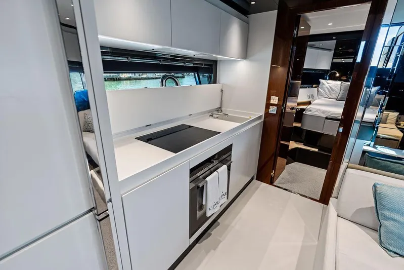 Club T Yacht Photos Pics Modern kitchen interior of 2023 Riva 68 Diable yacht, featuring sleek design and luxury amenities.