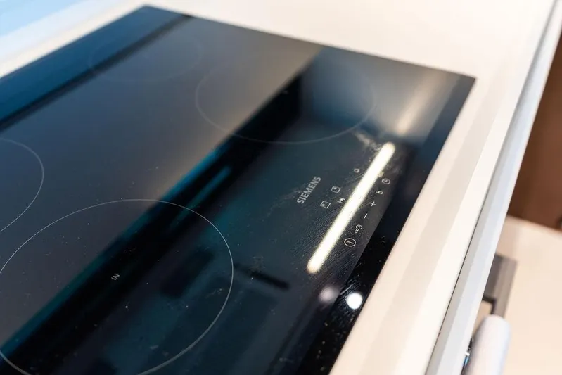 Club T Yacht Photos Pics Modern Siemens induction cooktop on 2023 Riva 68 Diable yacht kitchen.