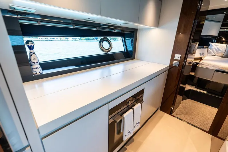 Club T Yacht Photos Pics Luxurious interior of 2023 Riva 68 Diable yacht with sleek cabinetry and modern design.