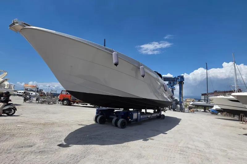  Yacht Photos Pics Otam 55 Millenium 1998 yacht on transport trailer in sunny shipyard.